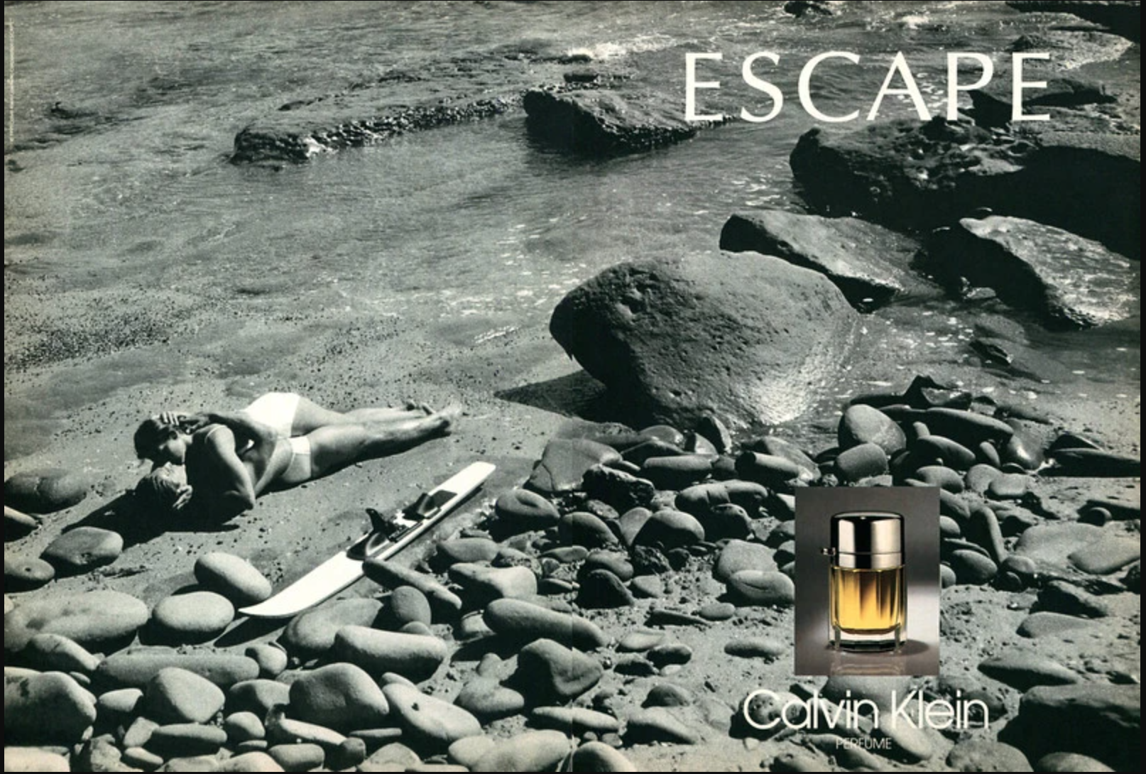 Calvin Klein perfume ad features the word "Escape" and two people on the beach making out